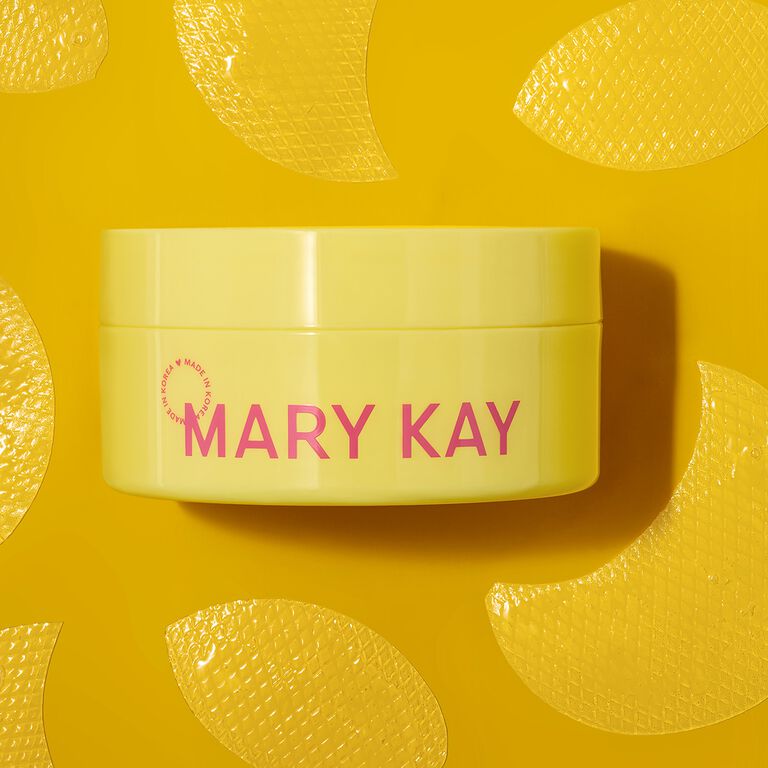 Profile view of woman with fun earrings and hairclips applying Mary Kay Unlimited Lip Gloss 
