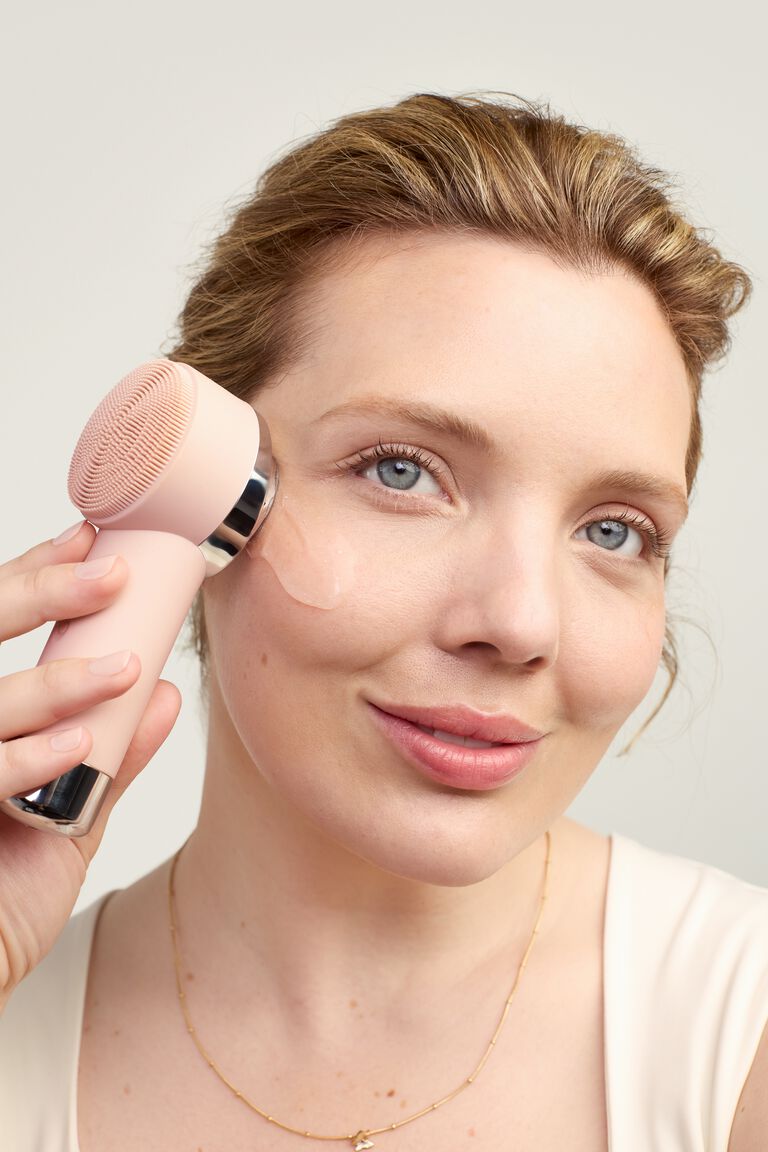 Modelo usando Skinvigorate Duo para darse un masaje t&eacute;rmico