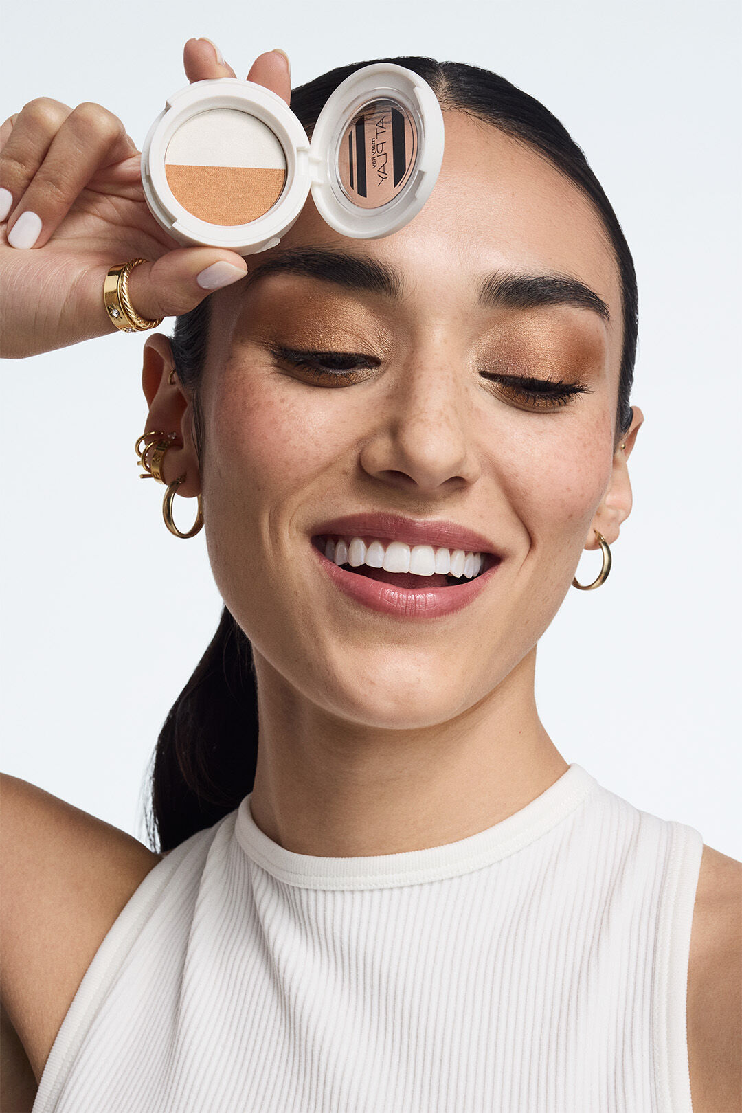 Hand holding a phone showing the Mary Kay Winter 2025 Look digital catalog.