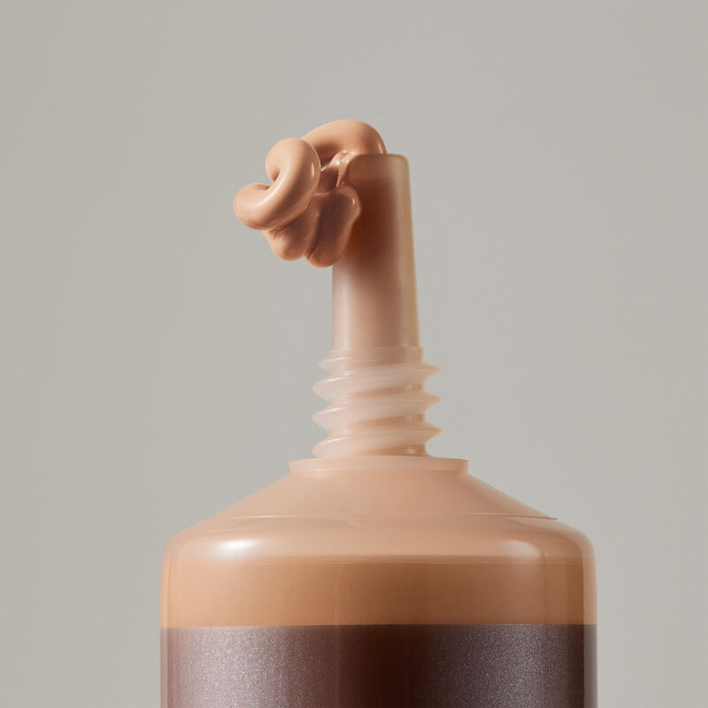 Macro view of TimeWise Matte 3D Foundation needle-nose applicator dispensing Medium 3 shade