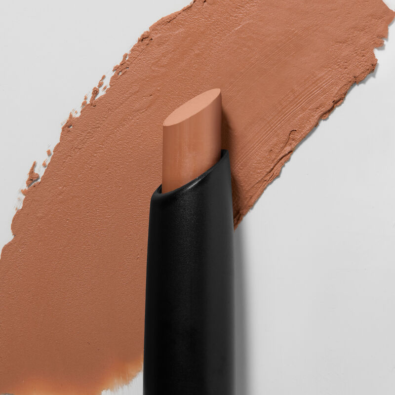 Mary Kay MattenbspEye Shadow Stick in Orbit Clay slanted tip in foreground swatch in background