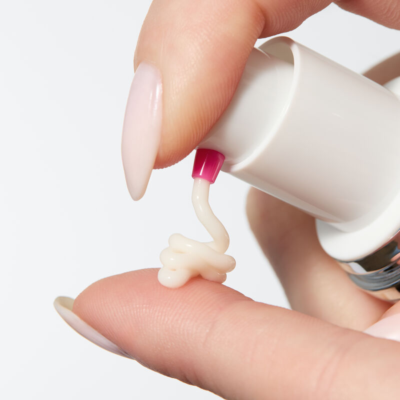 Hand pumping Mary Kay Clinical Solutions Barrier Restore 1:1:3 onto finger 