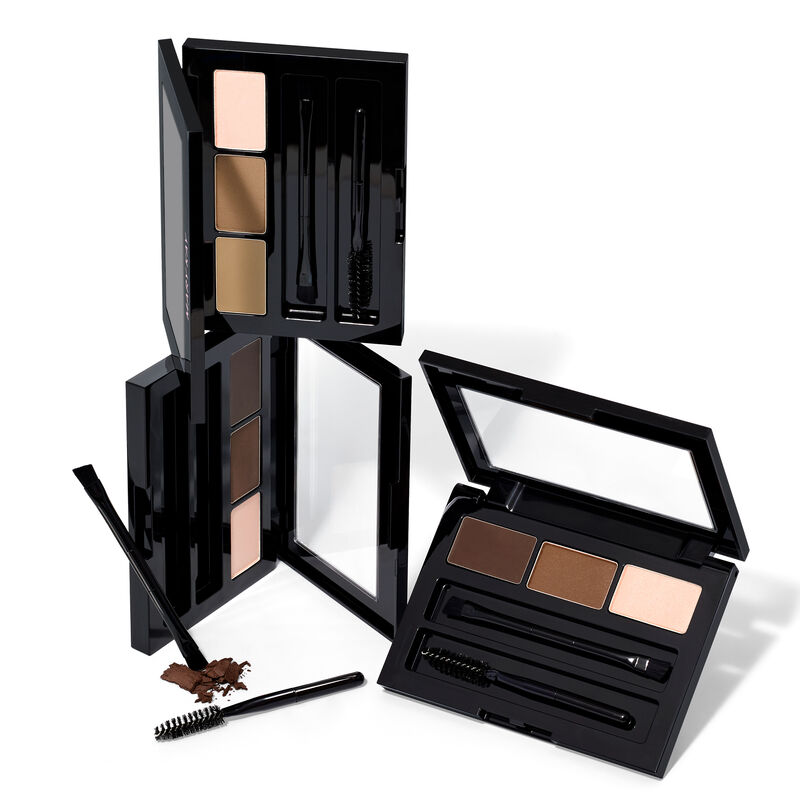 Stacked limited-edition Mary Kay Brow Kits in shades Blonde, Brunette and Dark Brunette against plain background
