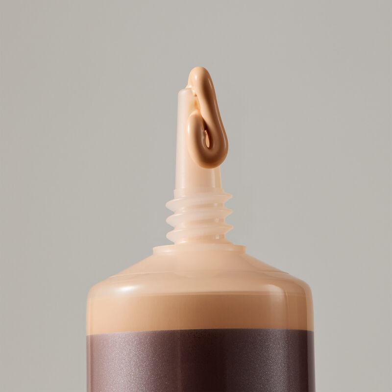 Macro view of TimeWise Matte 3D Foundation needle-nose applicator dispensing Light 3 shade