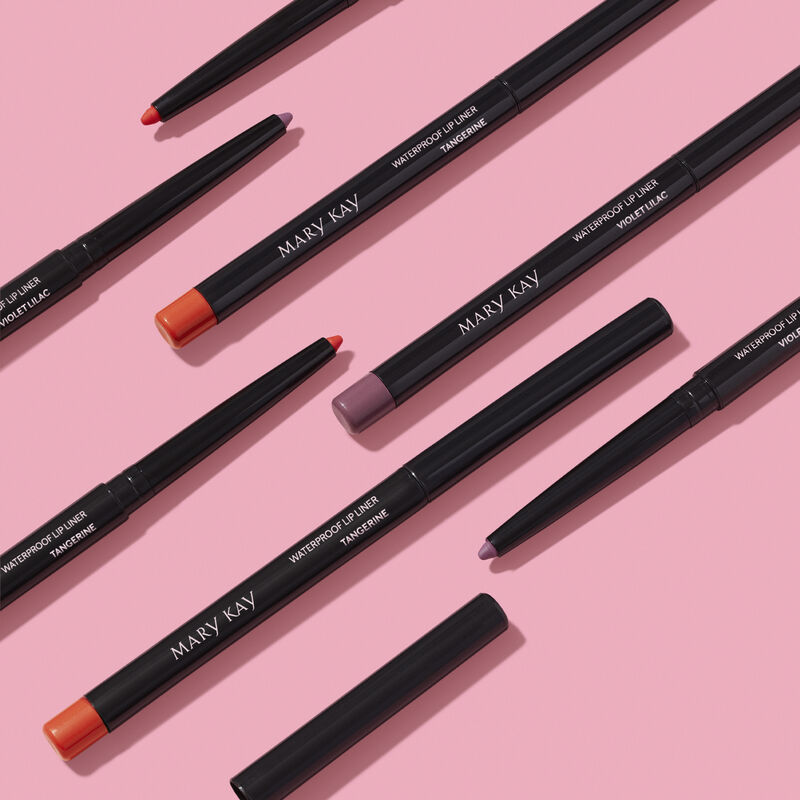 Pattern of special-edition Mary Kay Waterproof Lip Liner pencils in shades Tangerine and Violet Lilac against pink background