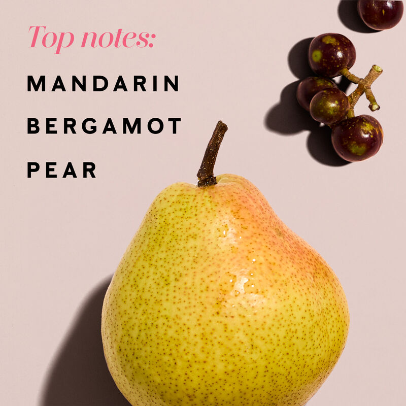 A pear lies on a light pink background.