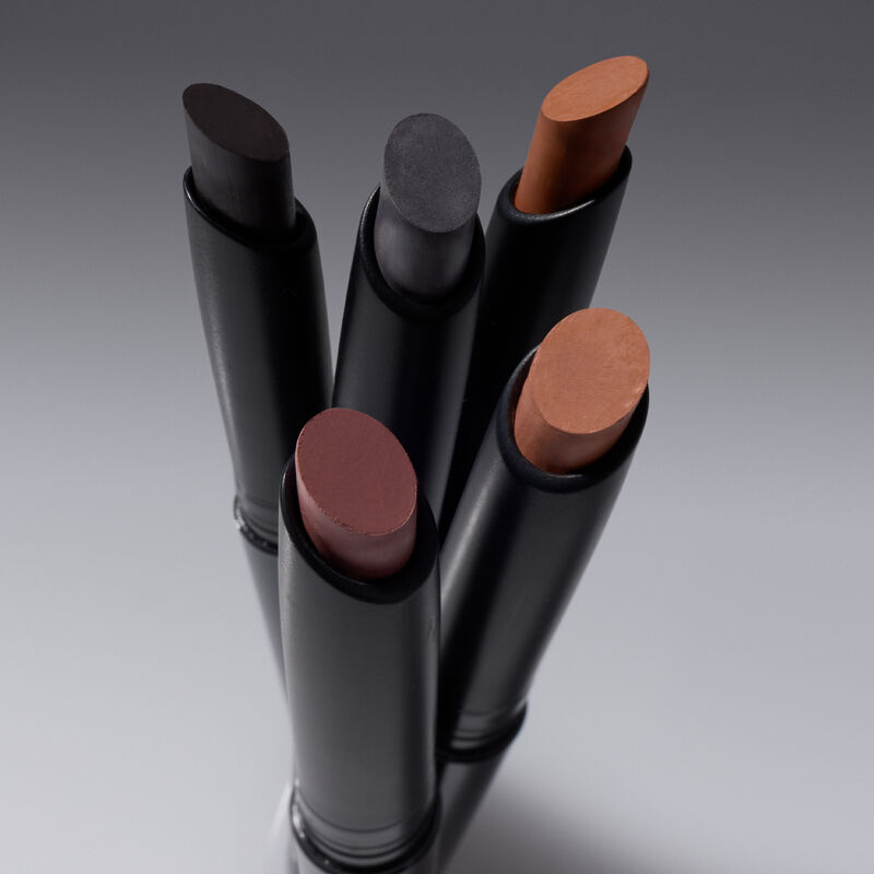 All five Mary Kay Matte Eye Shadow Sticks with caps off showing the full shade range