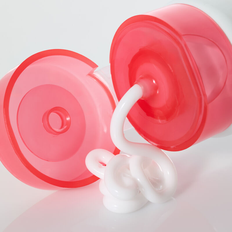 Mary Kay Hydrating Cream Mask lying on its side with cap open and creamy product swirling out