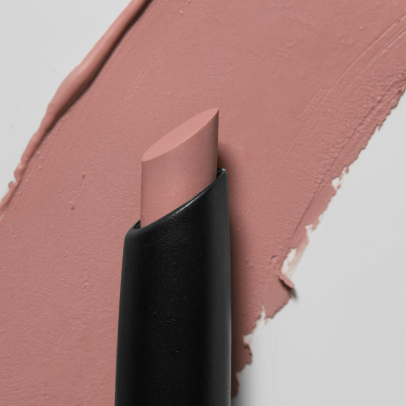 Mary Kay Matte Eye Shadow Stick in Lunar Rose slanted tip in foreground swatch in background