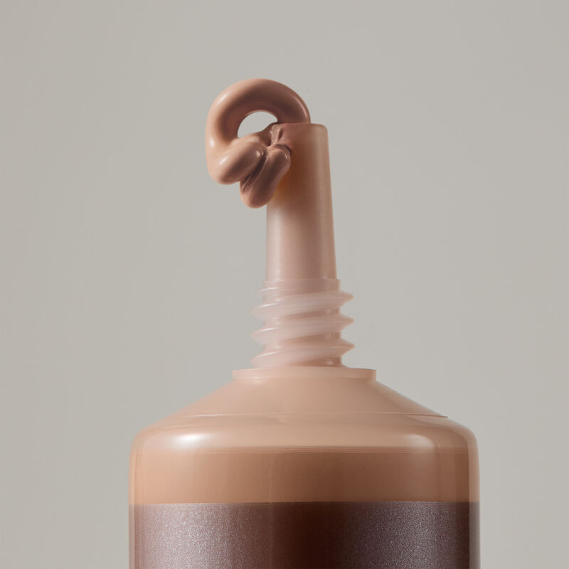 Macro view of TimeWise Matte 3D Foundation needle-nose applicator dispensing Medium 5 shade