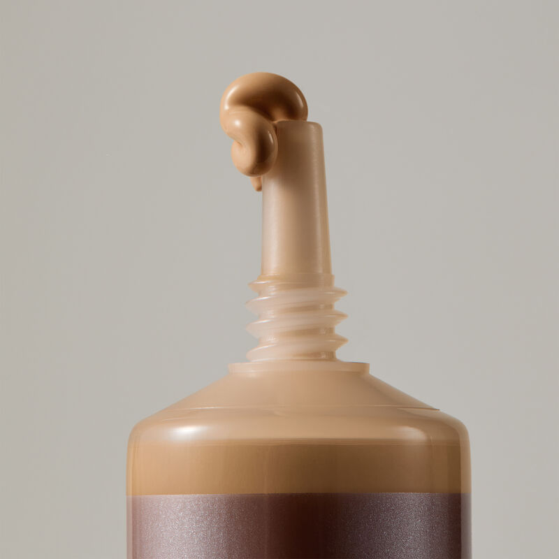 Macro view of TimeWise Matte 3D Foundation needle-nose applicator dispensing Medium 10 shade