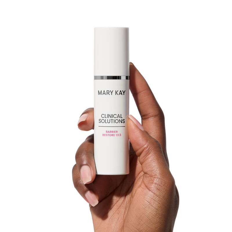 Hand holding bottle of Mary Kay Clinical Solutions Barrier Restore 1:1:3 