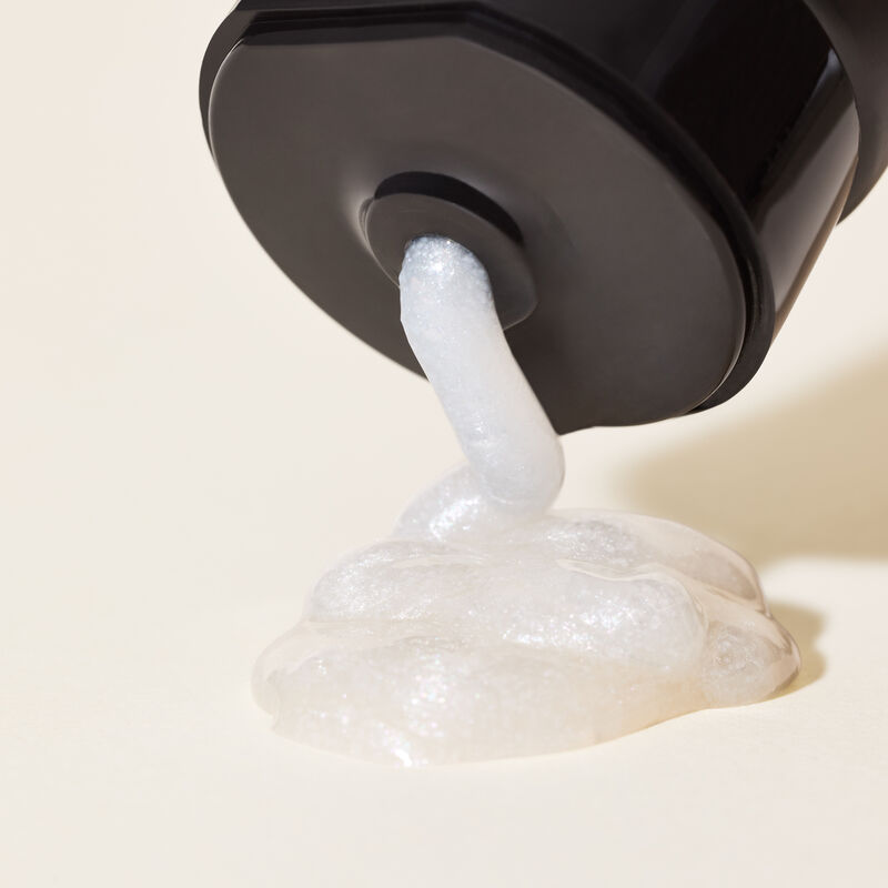 Close-up of limited-edition MKMen Invigorating Face Scrub product being squeezed from the tube