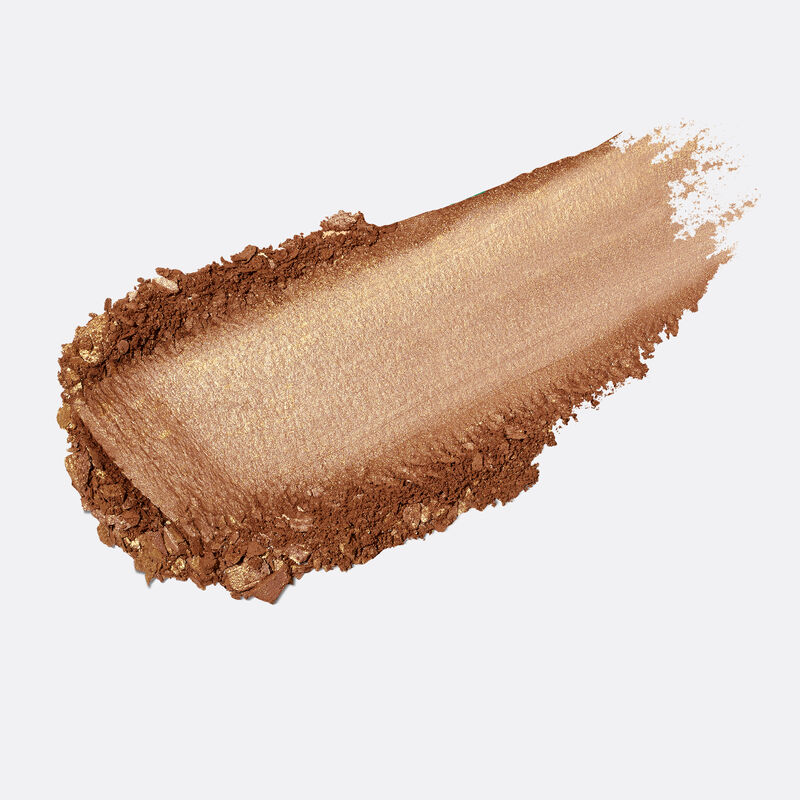 Product rub of limited-edition Mary Kay Illuminating Bronzer in shade Deep Glow against plain background