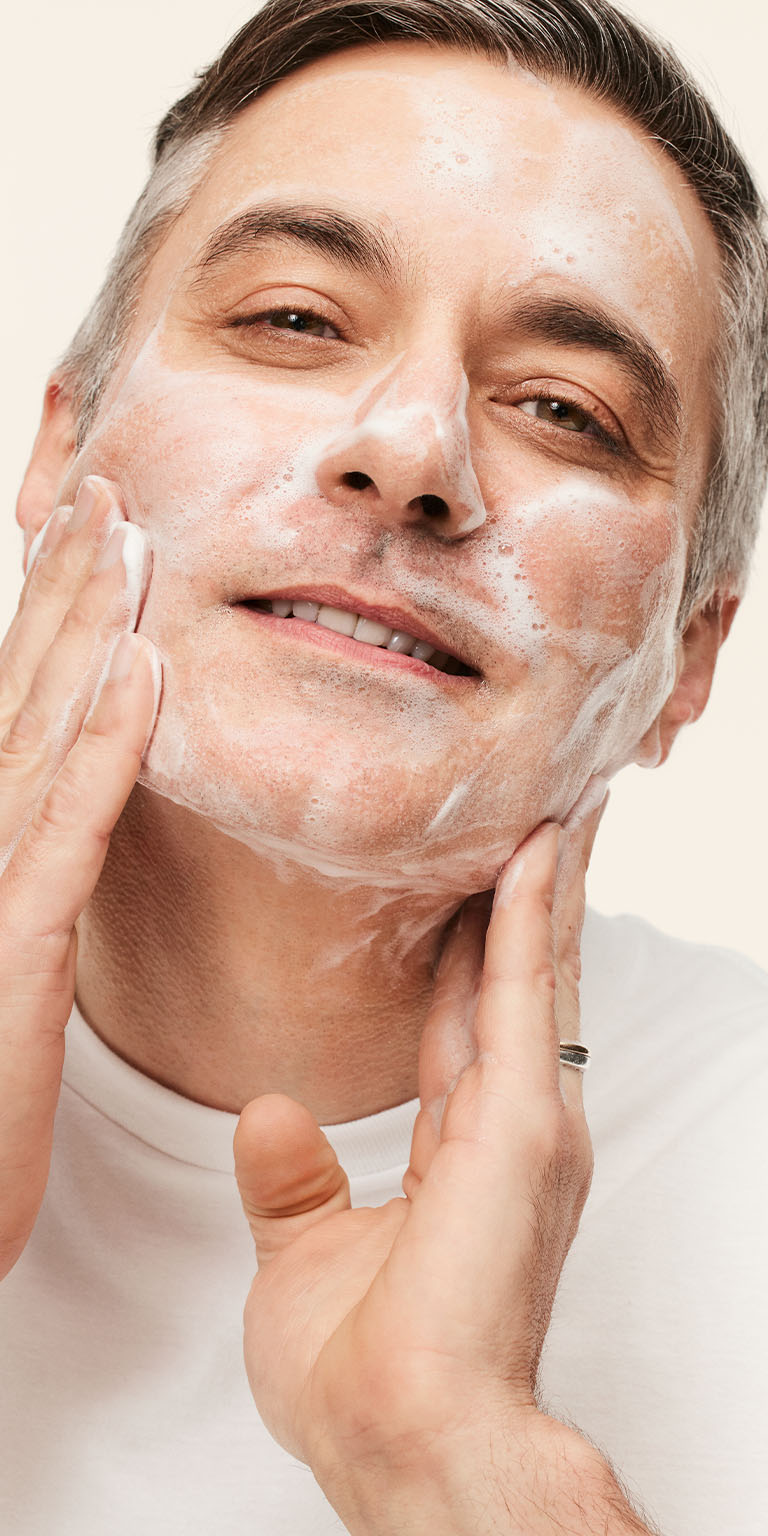 Modelo masculino aplicando el Gel Limpiador Facial MK Men&reg; en su rostro