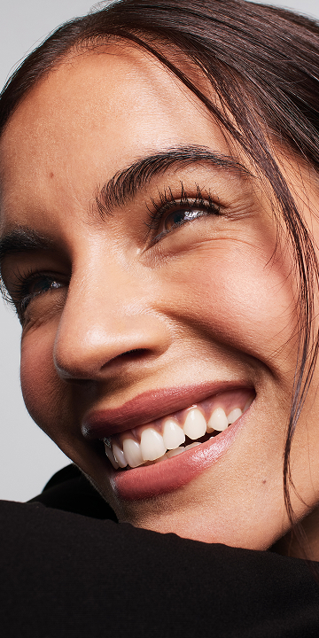 A close up of a woman with cleanser.