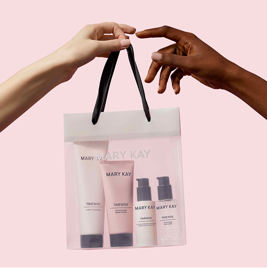 Persona entregando una bolsa con el set Mary Kay Timewise Miracle a alguien.