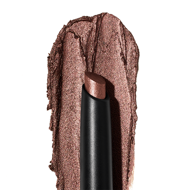 Sombra con Brillos para Ojos en Barra Mary Kay&reg; con muestra de textura de fondo.